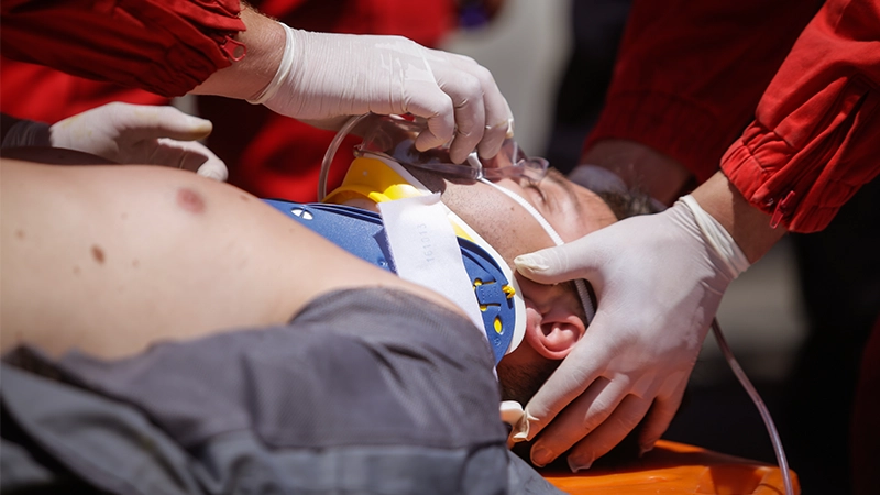 Paramedics rescue the victim of a car crash.