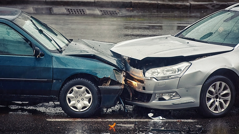 Two cars damaged after head-on collision.