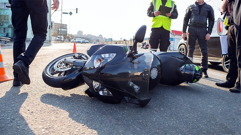 Broken motorcycle on the road accident site.