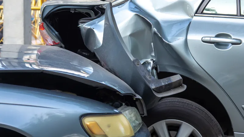 Car crash accident on street with wreck and damaged automobiles.