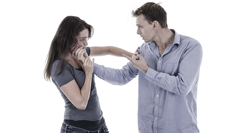 A man beating a woman.